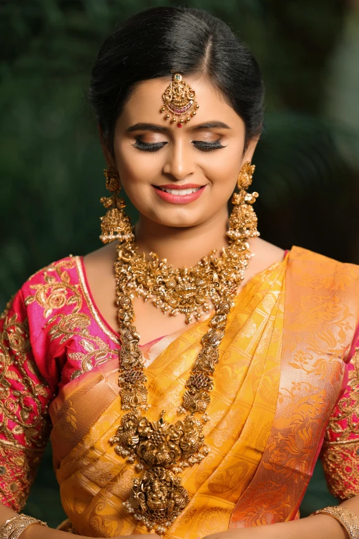 a woman wearing a very colorful jewellery and saree