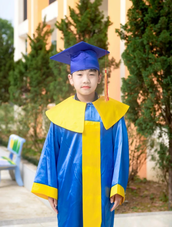  with blue graduation gown and yellow graduate's cap