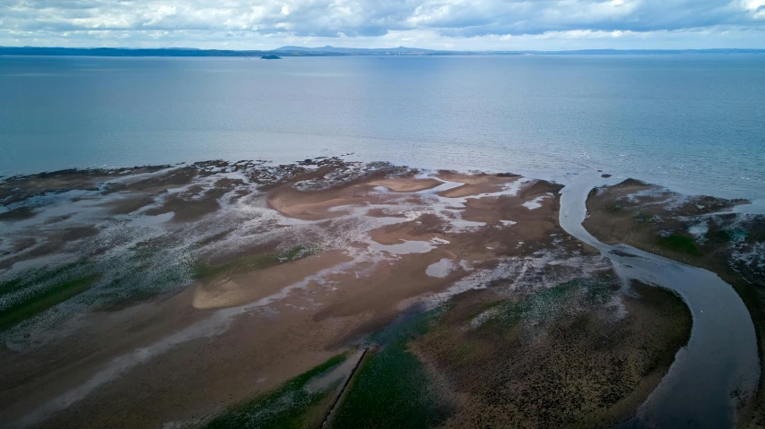 aerial po of the ocean with land in the middle