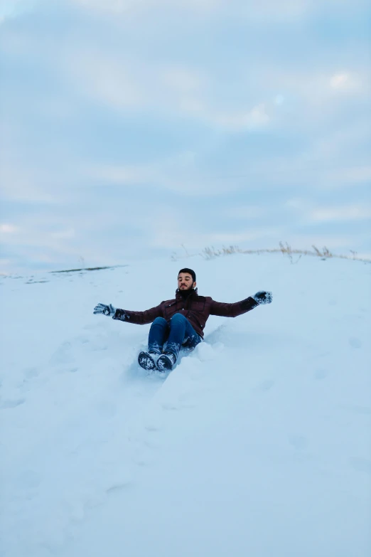 a man snowboarding down a snowy hill