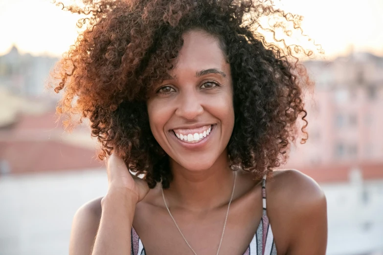 a woman is posing for a picture while smiling