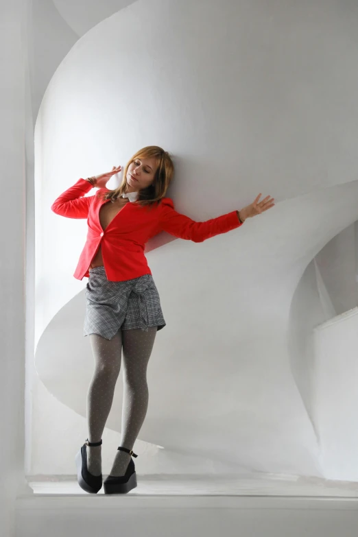 a woman posing in a room wearing black and white shoes