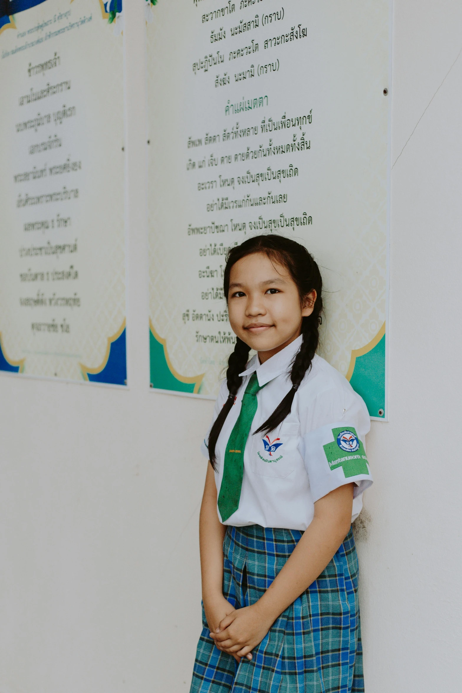 a  wearing a tie, with two white boards behind her