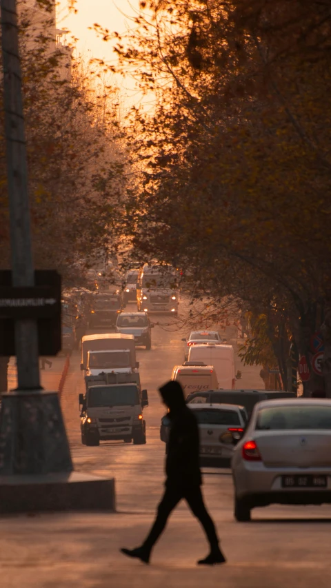 the man is crossing the street in traffic