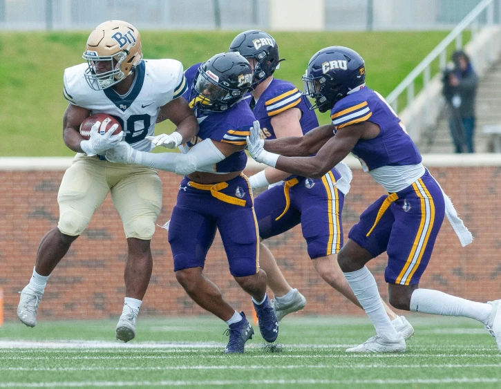 the football players are running for the ball