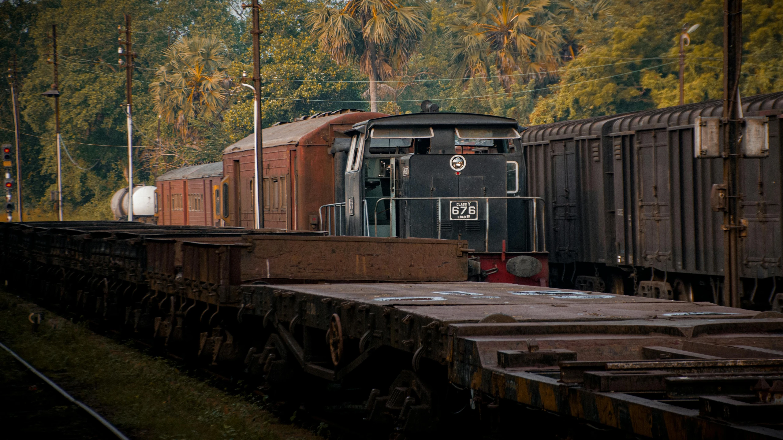 a old train engine pulling cars down a track