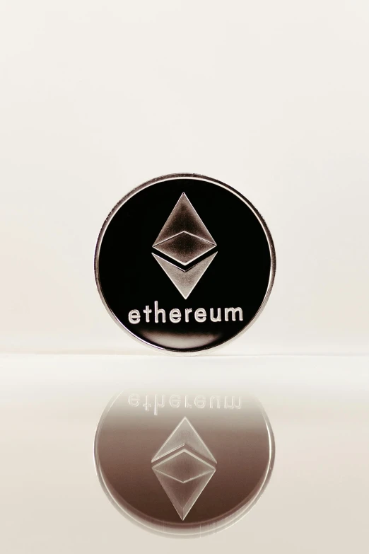 an emblem that reads etherum on a reflective surface