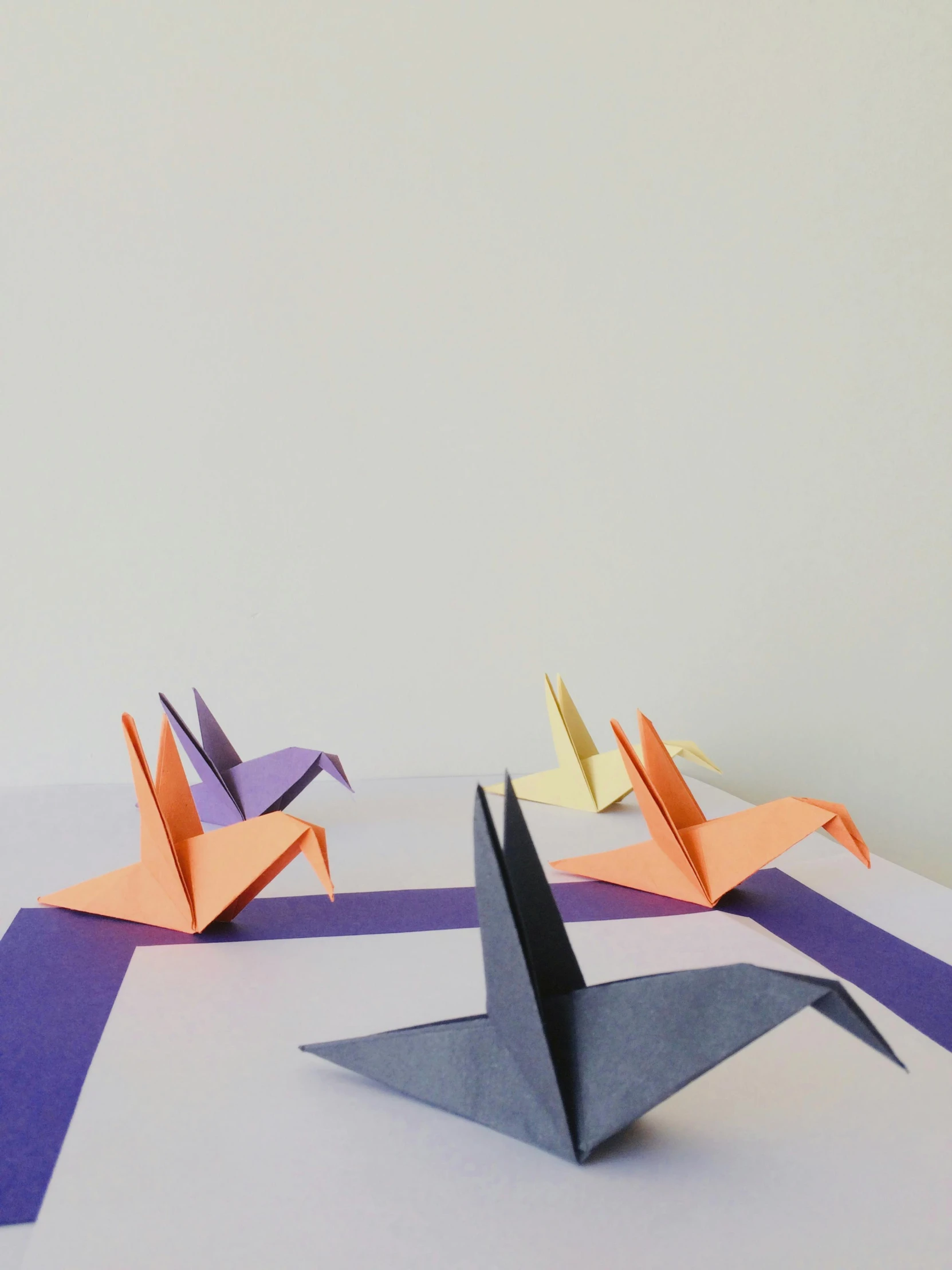 a group of three origami birds sitting on top of each other