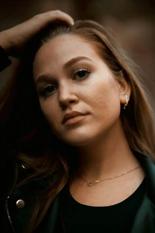 a woman is wearing earrings and black top