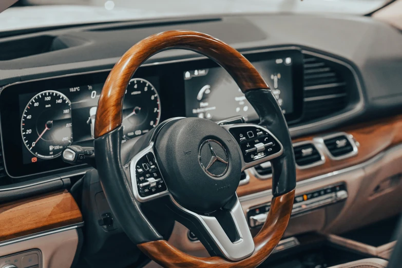 a steering wheel in a car with brown dashboard