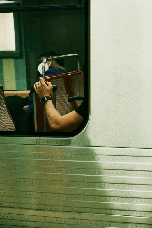 the reflection of a woman's reflection in a bus window