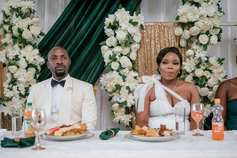 bride and groom sitting at the table during a toast service