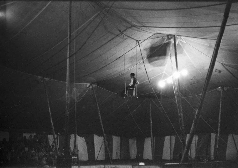 a black and white pograph of an individual on a rope