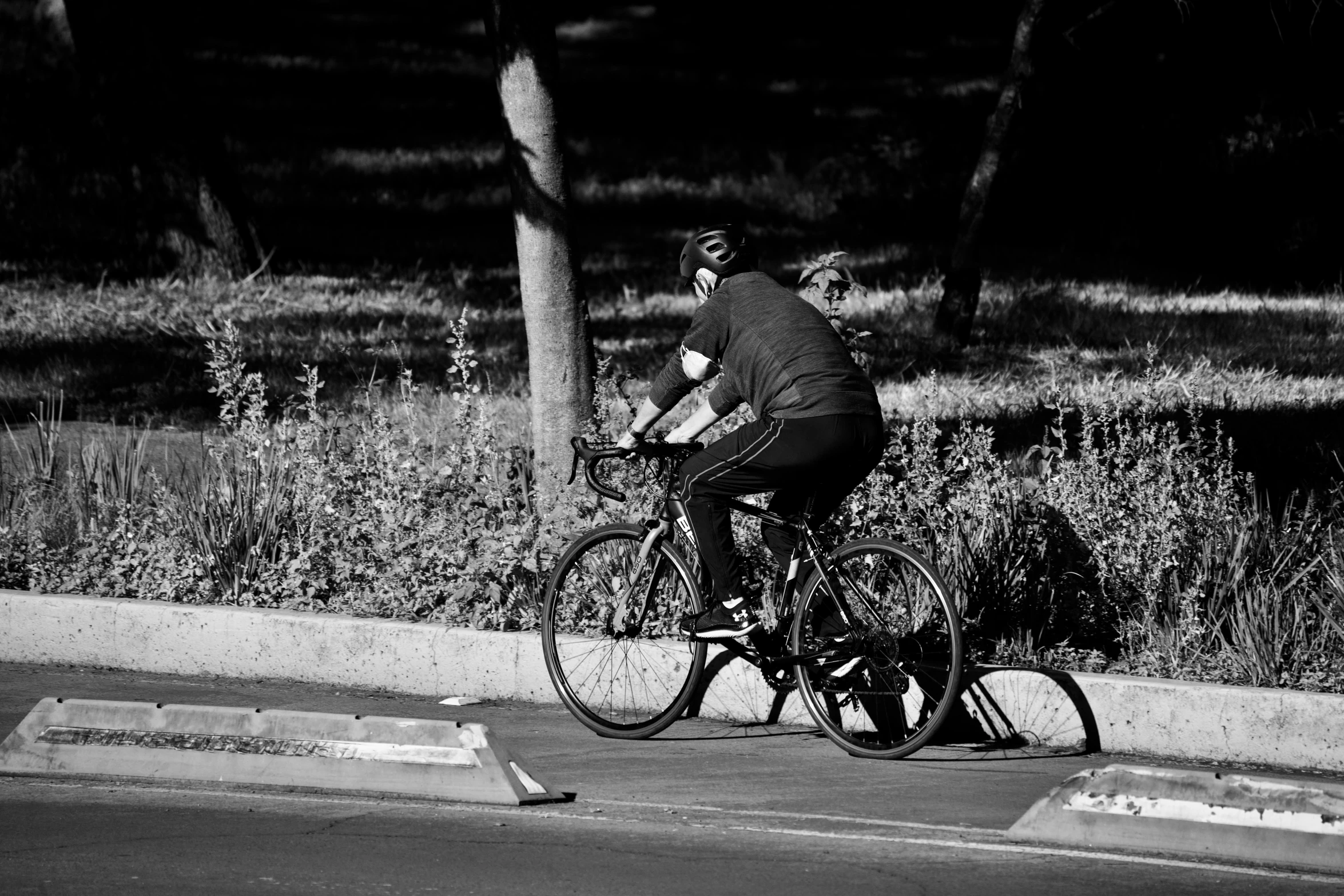 man riding a bicycle while holding onto his leash