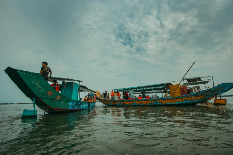 the two blue and yellow boats are in the water