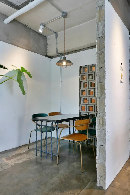 the concrete floor has been put in a corner by a table and four chairs