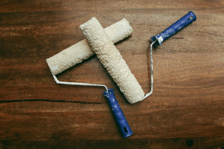 a cross is laying on the table with a roller on it