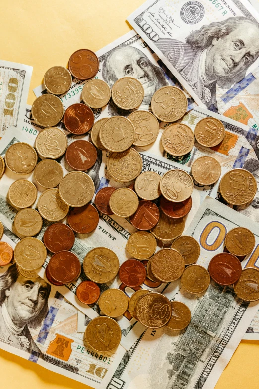 various coins and bills all piled in different patterns