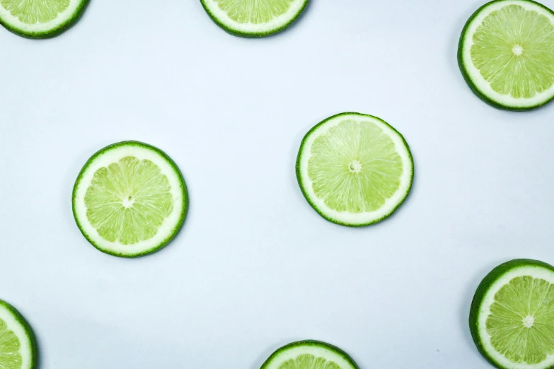 limes with segments in the middle are arranged on a blue background