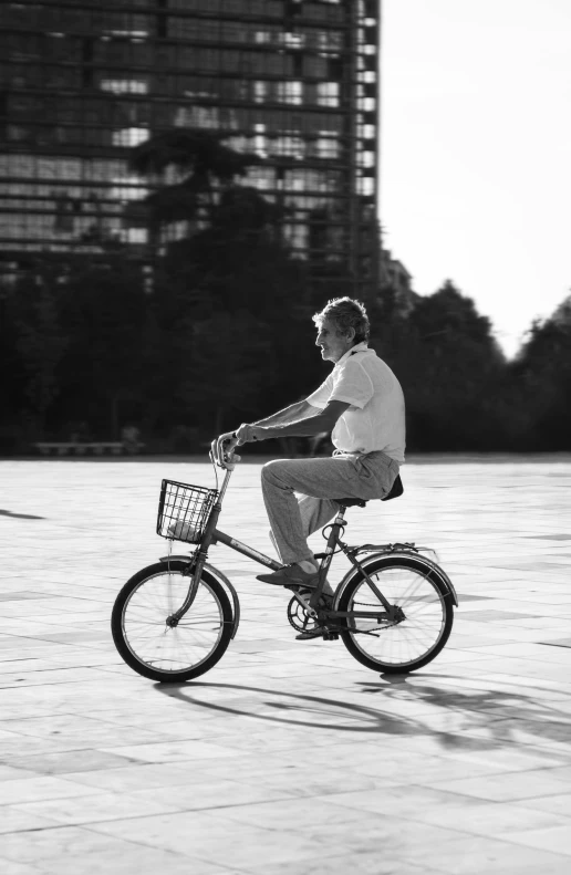 a man riding a bicycle while wearing white on