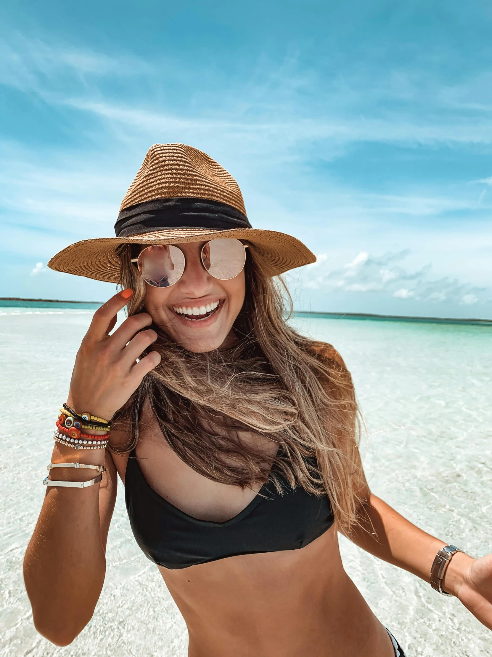 a woman wearing a hat while talking on her cellphone