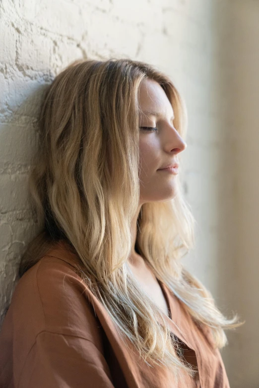 a woman is sleeping in a room while looking away from the wall