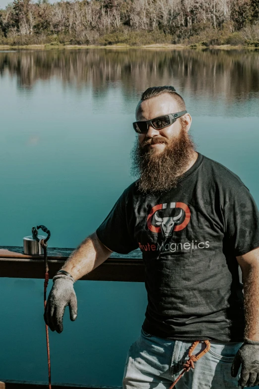 a man standing on a boat with gloves and a cane