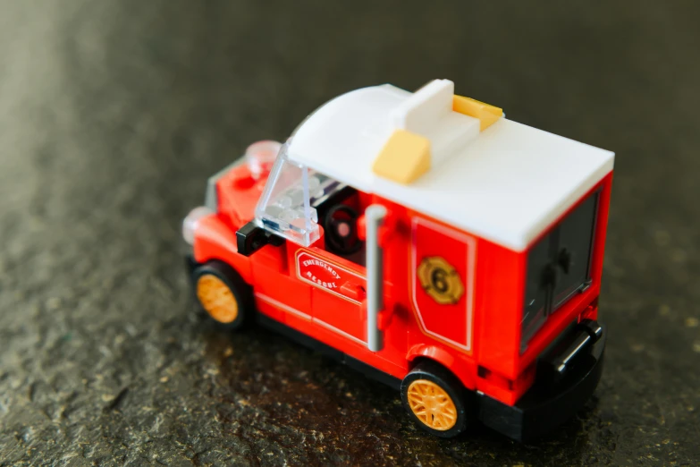 an image of a toy fire truck on the floor