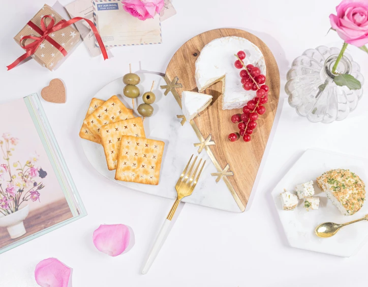 a table has ers, flowers and cake on it