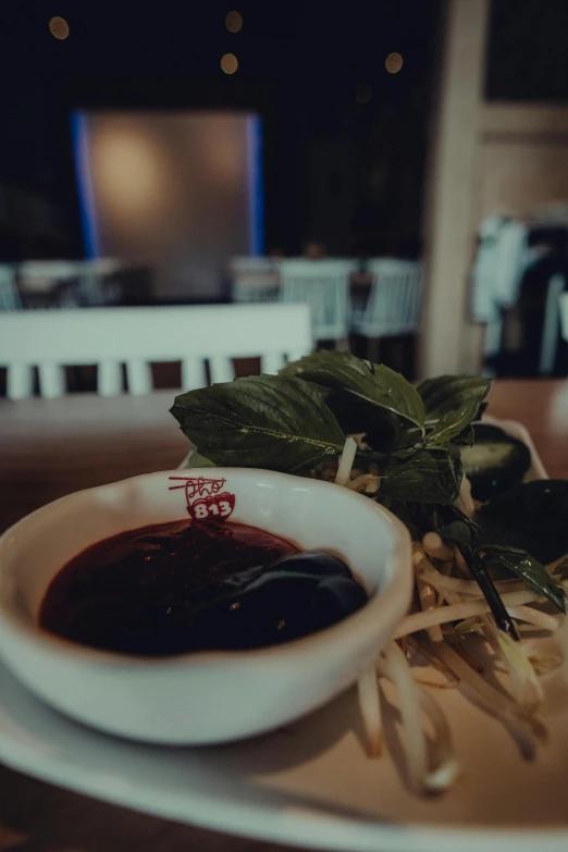 a bowl of soup sitting on top of a white plate