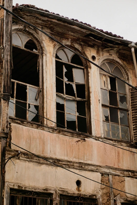 the window of an old building with lots of broken glass