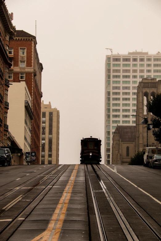 a train driving down the tracks during the day