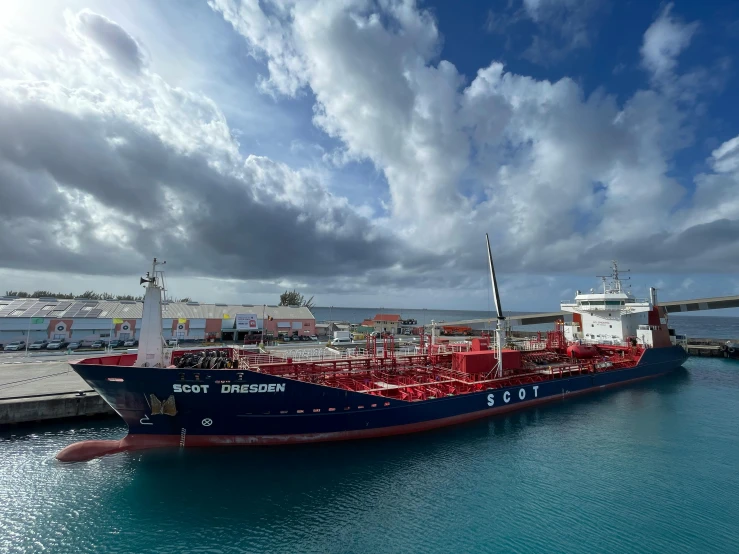 a blue and red ship in the water