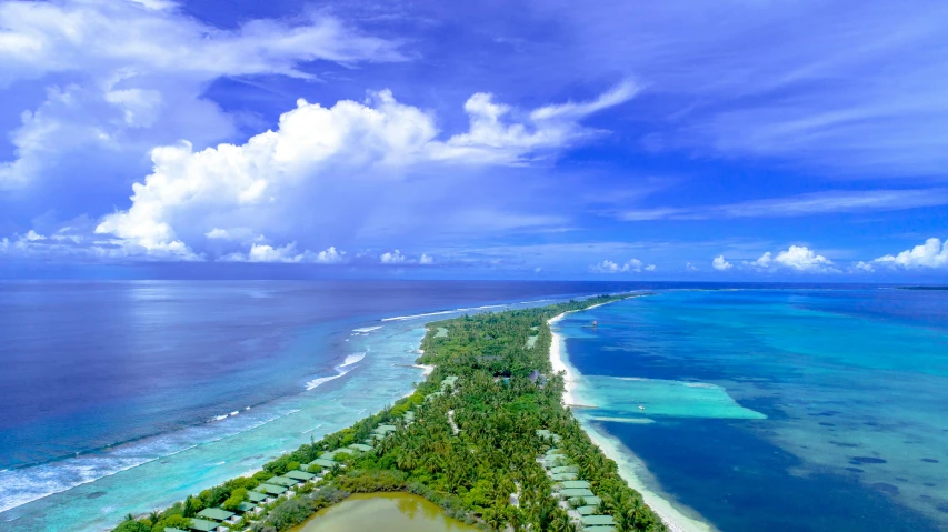 an aerial view of a beach and resort in the ocean