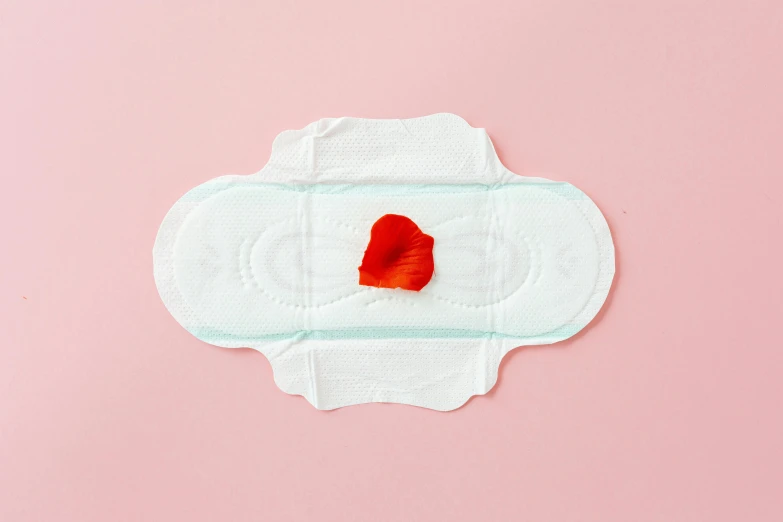 a paper heart on top of some medical pad