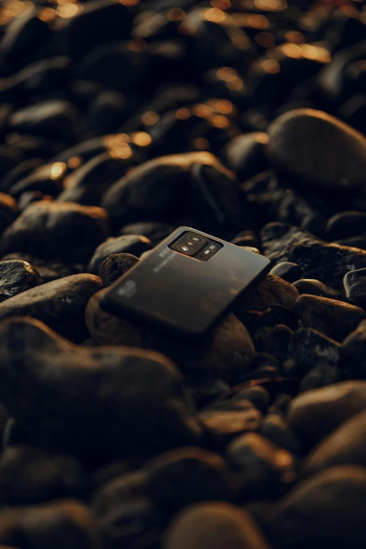 a po of a metal piece sitting on some rocks