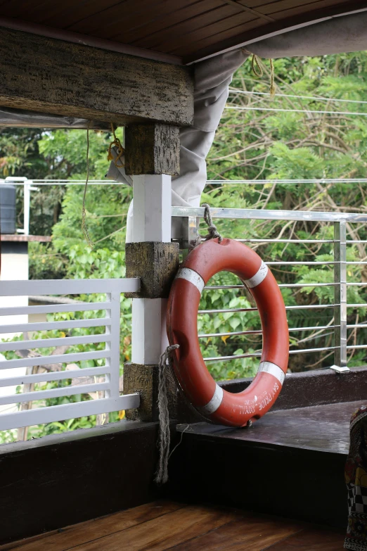 a life ring is hanging outside on a deck