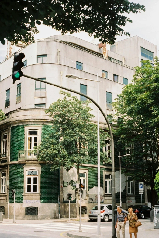 a couple of people on the street under a stop light