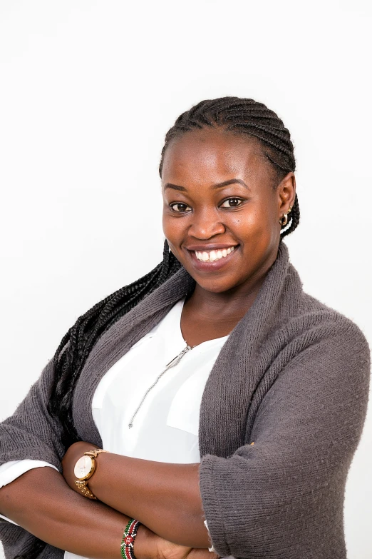 a woman standing and smiling at the camera