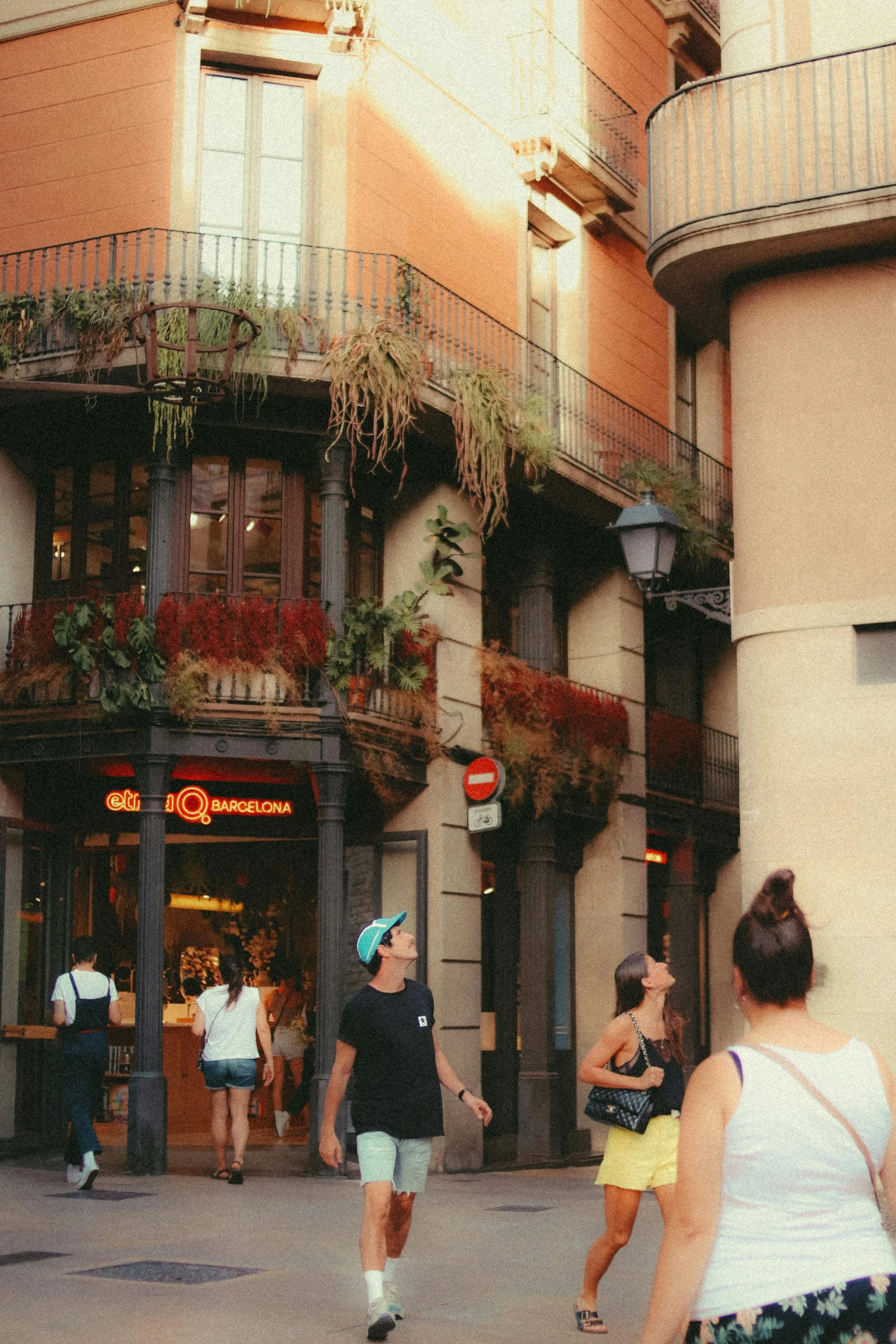 people in an alley with buildings on both sides