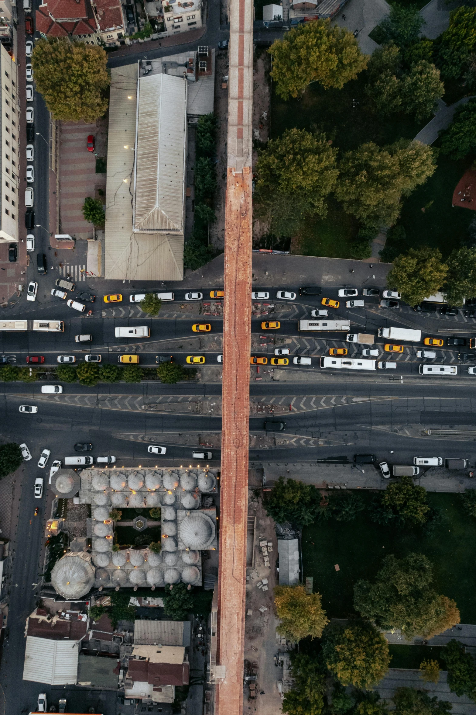 a large building with cars parked in the street below it