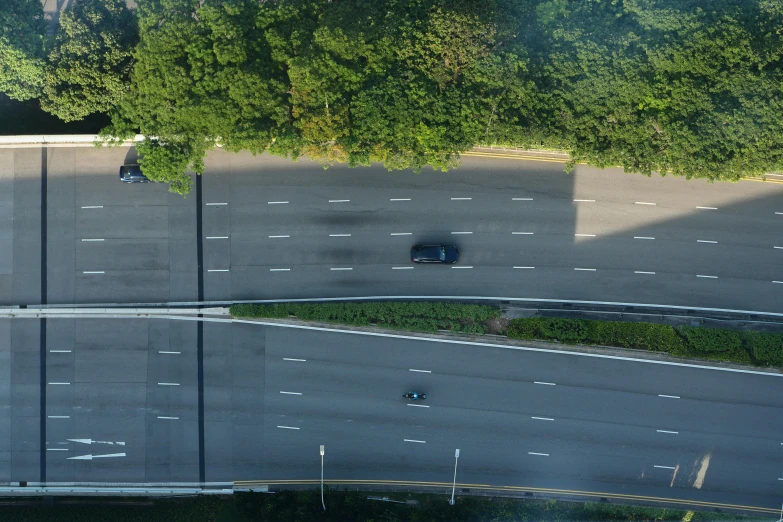 an overhead view of a street with multiple lanes and cars