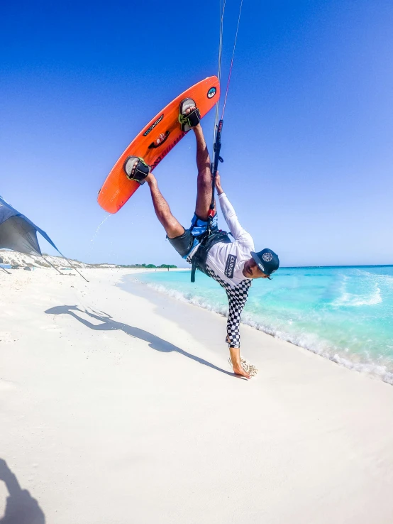 a man holding onto a surfboard above his head