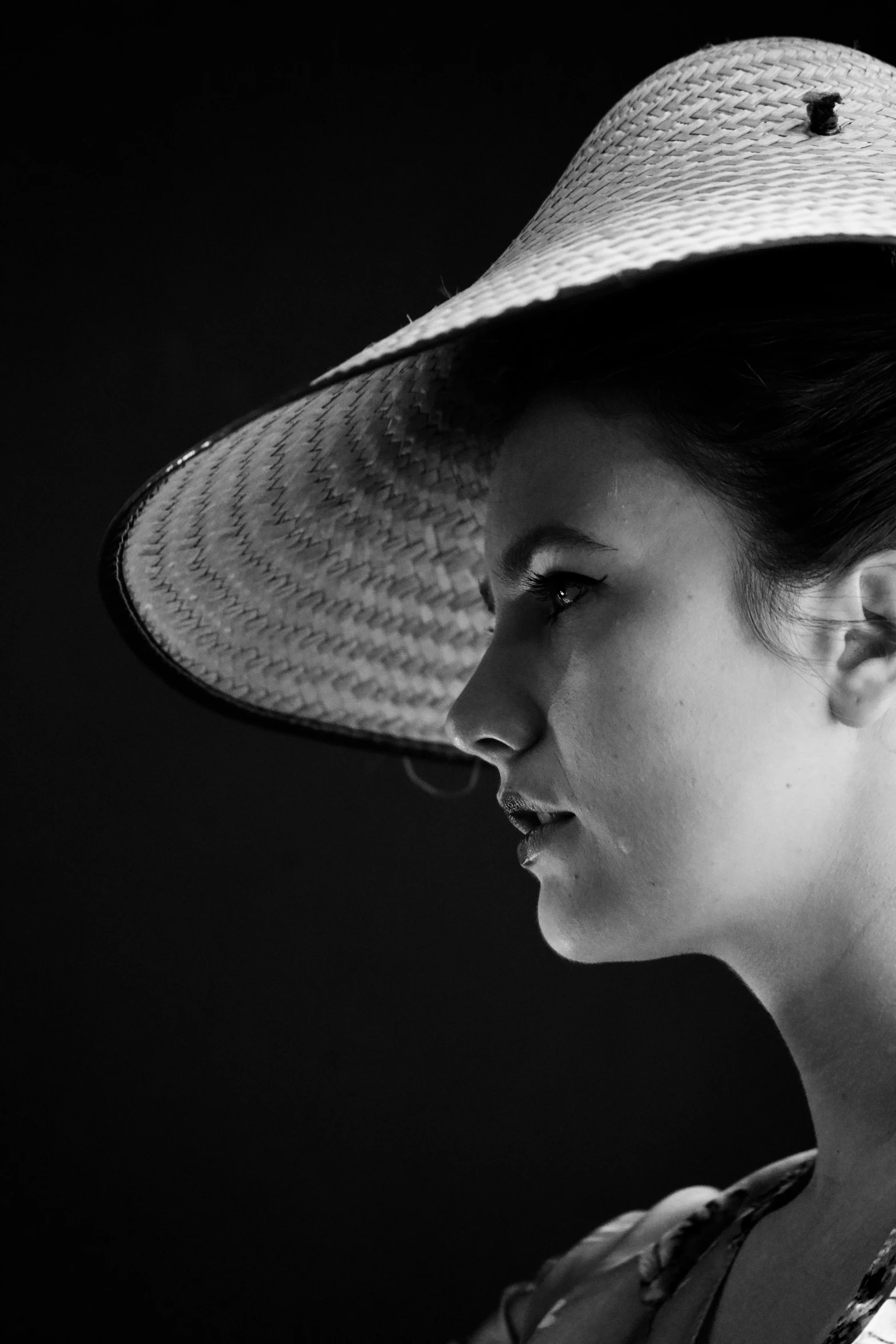 a black and white po of a woman in a hat