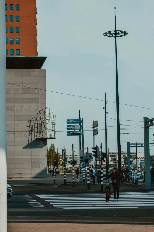 people crossing the street in front of some tall buildings