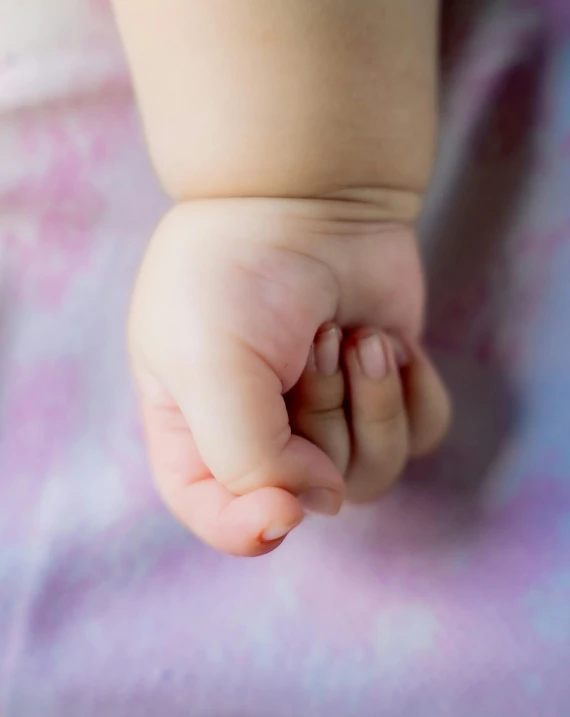 the foot of a baby on a blanket