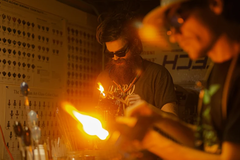 two men look at the flames in a bar