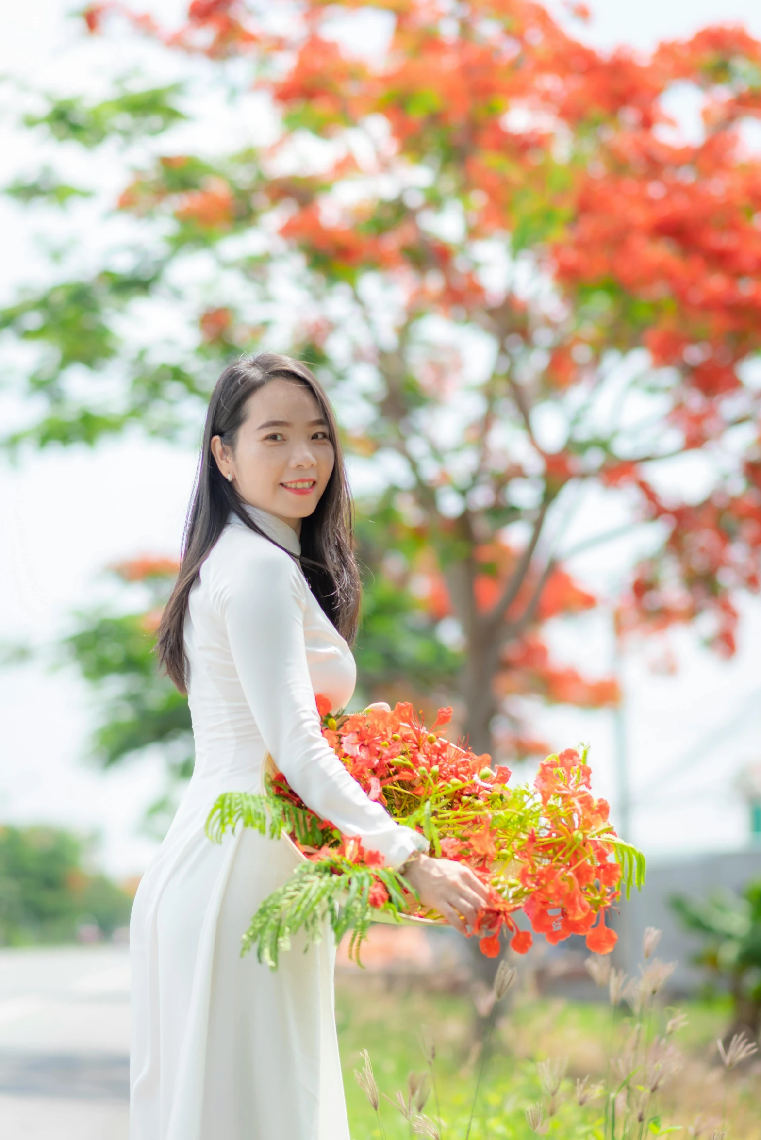 a beautiful young woman holding flowers in her hands