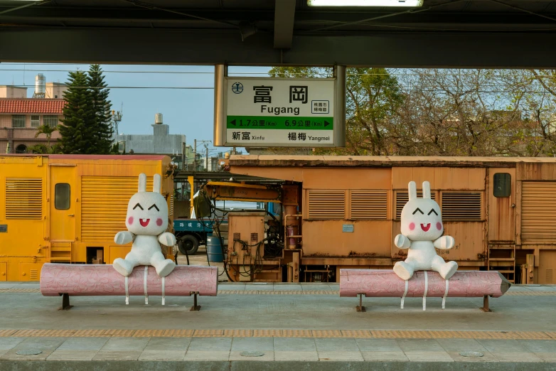 some stuffed animals are sitting on some benches