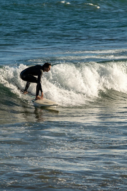 a man on a surfboard is in the ocean